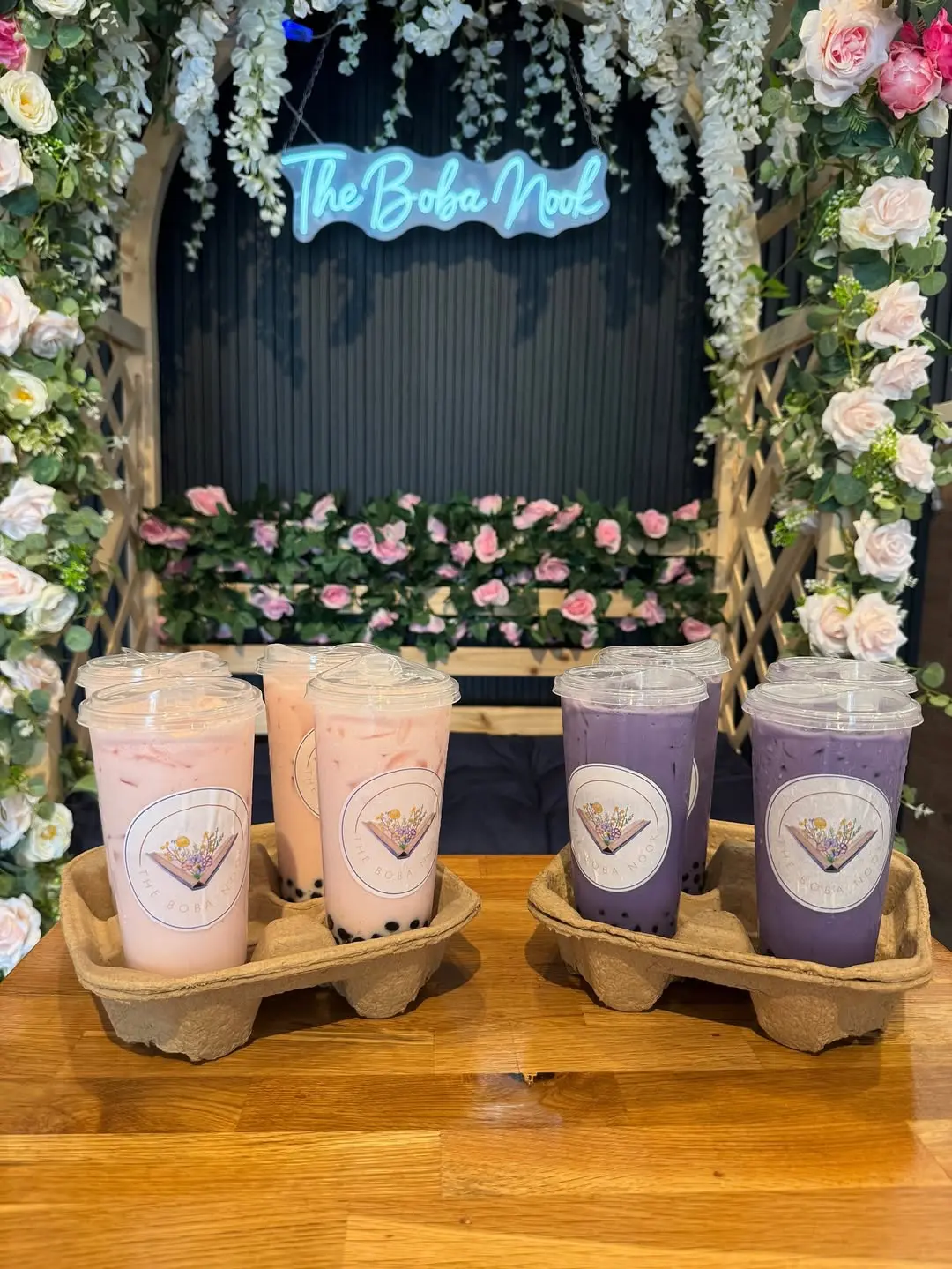 The Boba Nook drinks under a beautiful floral arch